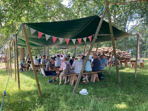 Large group eating under taupaulin at Ruskin Land.jpg